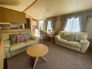 a living room with a couch and a table at 4 Berth Nearby Hunstanton Beach In Norfolk Ref 13018l in Hunstanton