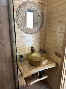 a bathroom with a sink and a mirror at One day in the village/ერთი დღე სოფელში in Batumi