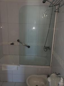a bathroom with a shower and a tub and a sink at PREMIUM MENDOZA in Mendoza +1 photo