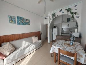 a living room with a couch and a table at NATALI Appartamens in Malcesine