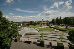 a view of a park with people sitting on benches at Gyulai idill apartman in Gyula