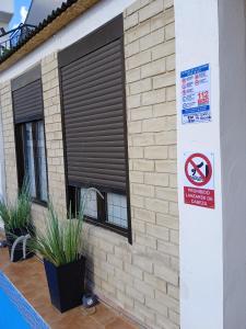 a building with a window with a no parking sign at Hostal Orange Vibes in Paterna