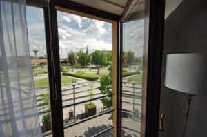 a window in a room with a view of a street at Gyulai idill apartman in Gyula +61 photos