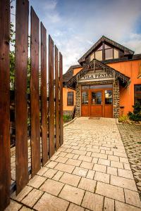 a building with a wooden fence in front of it at Vila Fenix B&B in Ružomberok