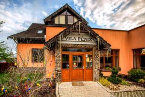 an orange building with a pizza parlor on it at Vila Fenix B&B in Ružomberok
