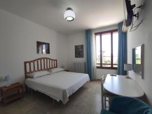 オートラントにあるPorta Alfonsinaのベッドルーム1室(ベッド1台、デスク、ベッドサイドシックスシックス付)