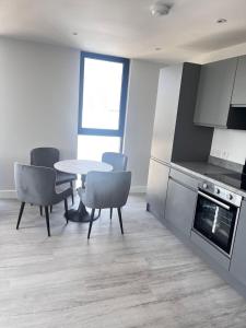 a kitchen with a table and chairs in a room at Executive Luxury stays 3 in Barking