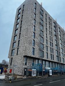 a large stone building on the side of a street at Executive Luxury stays 3 in Barking