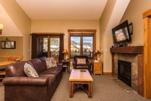 a living room with a couch and a fireplace at Springs by Summit County Mountain Retreats in Keystone