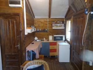 A kitchen or kitchenette at EXIT Camping with bungalow, mobile home, tents, and empty spots with private acces to the beach