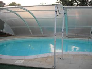 a pool with a cover over a swimming pool at studio 66 in Caumont-sur-Durance