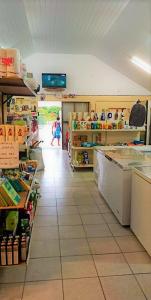 a grocery store aisle with a person walking in the distance at FAKARAVA - Teariki Lodge 2 in Fakarava
