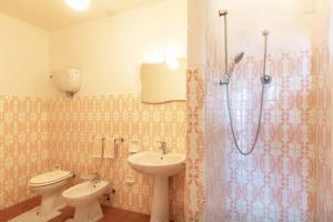 a bathroom with a sink and a toilet and a shower at Villa Due Laghi in San Feliciano +12 photos