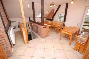 a kitchen with a fireplace and a table and chairs at Noclegi Dorotowo in Dorotowo