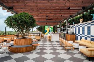 een patio met een tafel en stoelen en een boom bij Perry Lane Hotel, a Luxury Collection Hotel, Savannah in Savannah