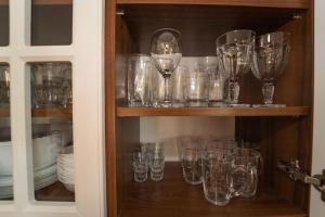 a cupboard filled with lots of wine glasses at Wilki2 in Wetlina