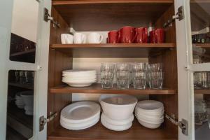 a cupboard filled with plates and glasses and bowls at Wilki2 in Wetlina