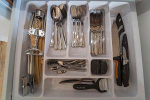 a white drawer filled with utensils at Wilki2 in Wetlina