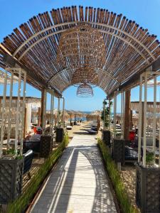 a pavilion at the beach with a chandelier at Dolce Vita Blue Boho, Premium Apartment with seaview in Sveti Vlas