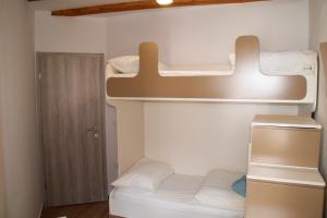 a small room with two bunk beds in it at Apartments ELA in Piran