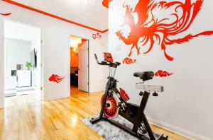 a gym with a exercise bike in a room with a dragon mural at Private 3 bedrooms, Free parking, Private bathroom in Lower Sackville