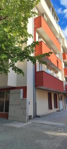 an apartment building with an orange and white at Kiki Home in Blagoevgrad