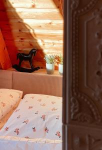 a bed in a room with a wooden ceiling at Kleines Chalet im Erzgebirge mit Sauna und Kamin in Rechenberg-Bienenmühle