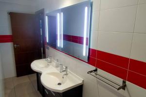 a bathroom with a sink and a mirror at Alcalá Center Playa in Alcalá