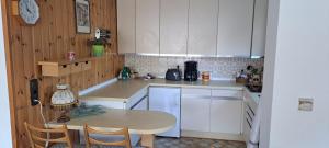 a kitchen with a table and a table and chairs at Retrowohnung Lindenhof Oberndorf in Oberndorf