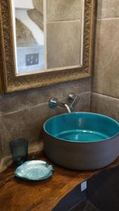 a blue sink on a wooden counter in a bathroom at La Maddalena Exclusive villas in La Maddalena