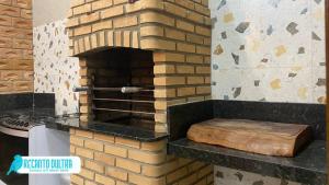 a brick oven with a wooden cutting board in it at Recanto Dutra in Olímpia