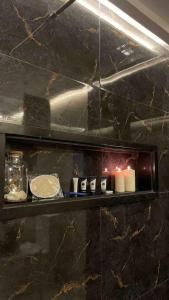 a shelf with candles on it with a counter at Luxury apartment in Fez