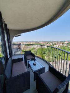 a balcony with couches and a table with a view at Primero Top-Suite 22 Stock Messe Zentrum Kongress in Augsburg