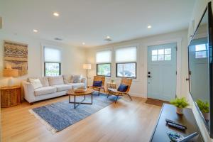 a living room with a couch and a table at Beautiful Cape May Cottage Walk to Beach and Mall! in Cape May