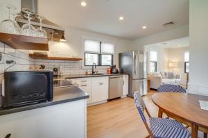 a kitchen and dining room with a table and chairs at Beautiful Cape May Cottage Walk to Beach and Mall! in Cape May