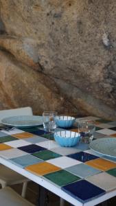 a table with plates and bowls on a checkered table cloth at La Maddalena Exclusive villas in La Maddalena +21 photos