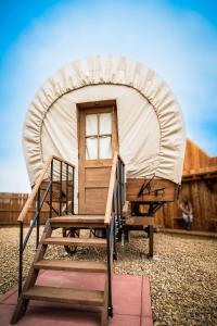 a yurt with a ladder and a door at The Big Texan - Cabins and Wagons in Amarillo