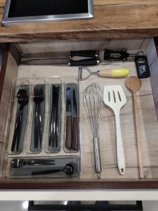 a drawer filled with utensils on top of a counter at Apartmani SLADJANA in Novi Sad