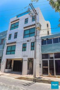 a white building on the corner of a street at Dodo Plaza Machado in Mazatlán