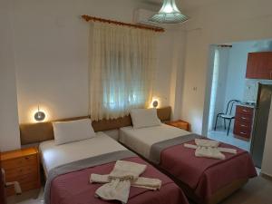 2 łóżka w pokoju hotelowym z ręcznikami w obiekcie Itamos House Vourvourou w mieście Vourvourou