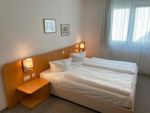 a bedroom with a large bed with white sheets at Apartment Jette mit Balkon in Zempin