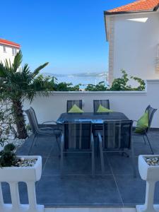 a patio with a table and chairs on it at Apartments Imperium in Trogir