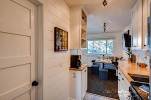 a kitchen with white cabinets and a counter top at Amazing Renovation, Premium Top Floor Unit Near Downtown, Access to Hot Tubs and Firepit PM6B in Breckenridge