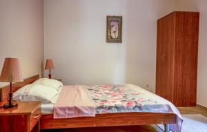 a bedroom with a bed and a table and a picture on the wall at Nature View Vacation Flat in Ulcinj, Montenegro in Ulcinj