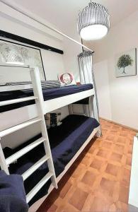 a room with two bunk beds with a ladder at Alghero Sa Stella Casa Vacanze in Fertilia
