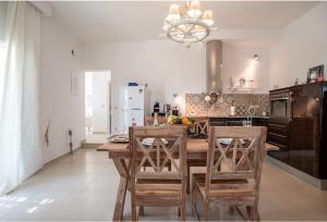 a kitchen with a wooden table and some chairs at Villa Sofia in Stelida