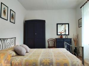 a bedroom with a bed and a cabinet and a mirror at Apartment 'Angelo' in traditional stone house in Slime