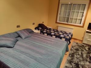 Postel nebo postele na pokoji v ubytování CASA PEDRASRUBIAS