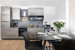 a kitchen with a table with chairs and a dining room at ARIA Sea View Apartment in Malinska