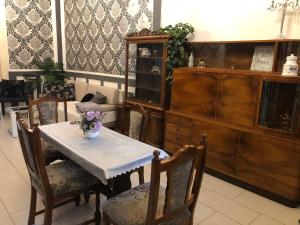 a dining room with a table with flowers on it at Secession Luxury Apartment in Budapest